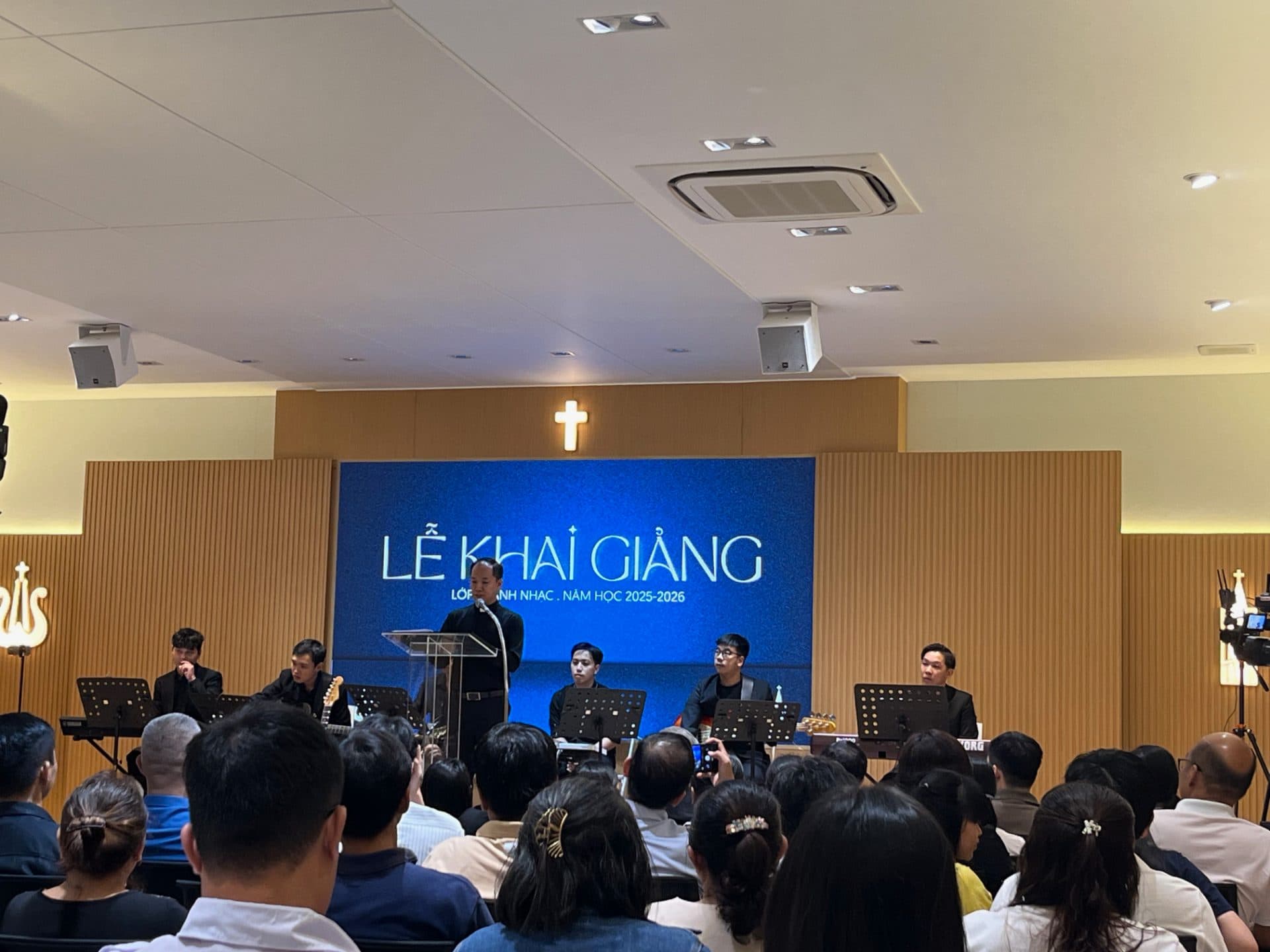 Cha Daminh Nguyễn Thứ Trưởng giảng lễ khai giảng lớp Thánh Nhạc trước giáo dân tại phòng đa năng Giáo Xứ Võ Dõng, với hệ thống loa YME lắp trần và micro không dây.